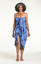 Woman wearing an indigo blue multicolored sarong against a white background. 