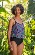 Lifestyle image of model wearing a Colorburst Blouson One Piece.