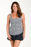 Woman wearing a black and white patterned swim dress on a white background