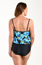 Woman wearing a black one piece swimsuit with blue floral pattern on a white background