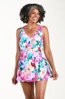 Woman wearing a colorful floral swim dress on a white background