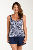 Front image of model wearing a multicolored navy blue paisley printed tankini top featuring wide shoulder straps, a scoop neckline, and a fitted silhouette. This is paired with indigo (navy blue) colored swim shorts.