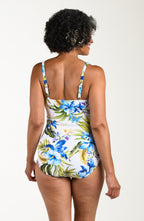 Back image of model wearing a multicolored (white) tropical one-piece with wide adjustable straps, V-neckline, twist front and front ruching. 