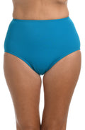 A close-up of a model wearing high-waisted, solid turquoise blue bikini bottoms against a plain white background.