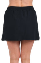Model is wearing a solid black woven boardskirt bottom.