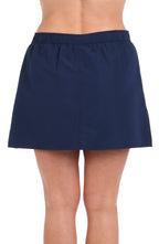 Model is wearing a solid indigo woven boardskirt bottom.