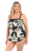 Woman wearing a black floral tankini top on a white background