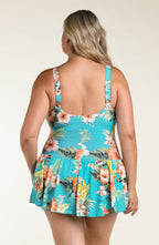 Woman wearing a floral swim dress with a white background