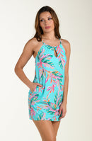 Woman wearing a colorful tropical cover up dress on a white background