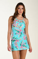 Woman wearing a tropical tankini top and matching swim skirt  on a white background