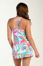 Back image of model wearing a multicolored tropical printed swim skort featuring twist front detail and full coverage. This is paired with a matching tankini top.
