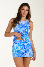 Woman wearing a blue floral tankini and swim skirt against a white background