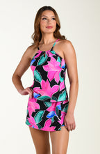 Front image of model wearing a multicolored tropical printed swim skort featuring twist front detail and full coverage. This is paired with a matching tankini top.