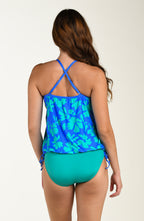 Back image of model wearing a multicolored floral printed tankini top featuring over the shoulder convertible straps, a straight back, and adjustable side ties. This is paired with an emerald colored bottom.