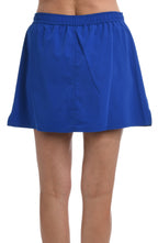 Model is wearing a solid cobalt woven board skirt bottom.