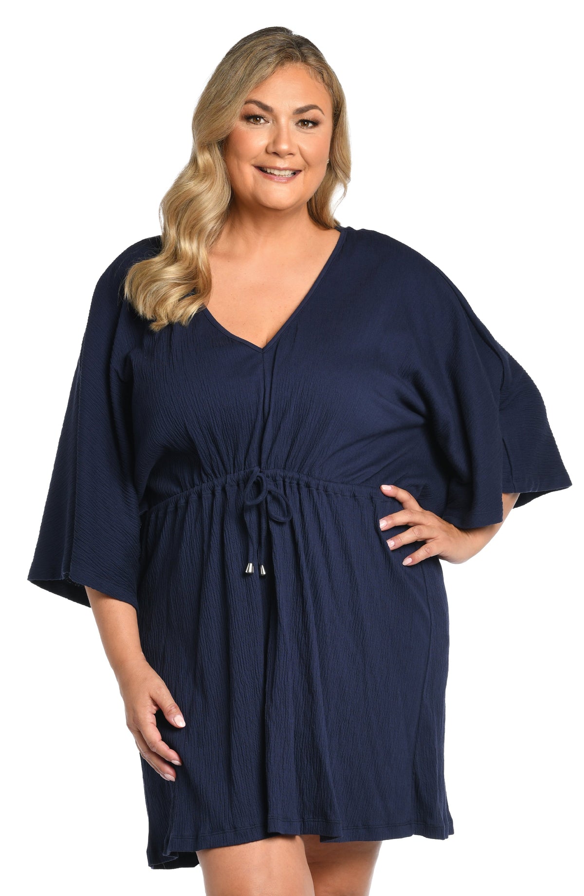 Model is wearing a solid navy blue colored front tie tunic cover up. 