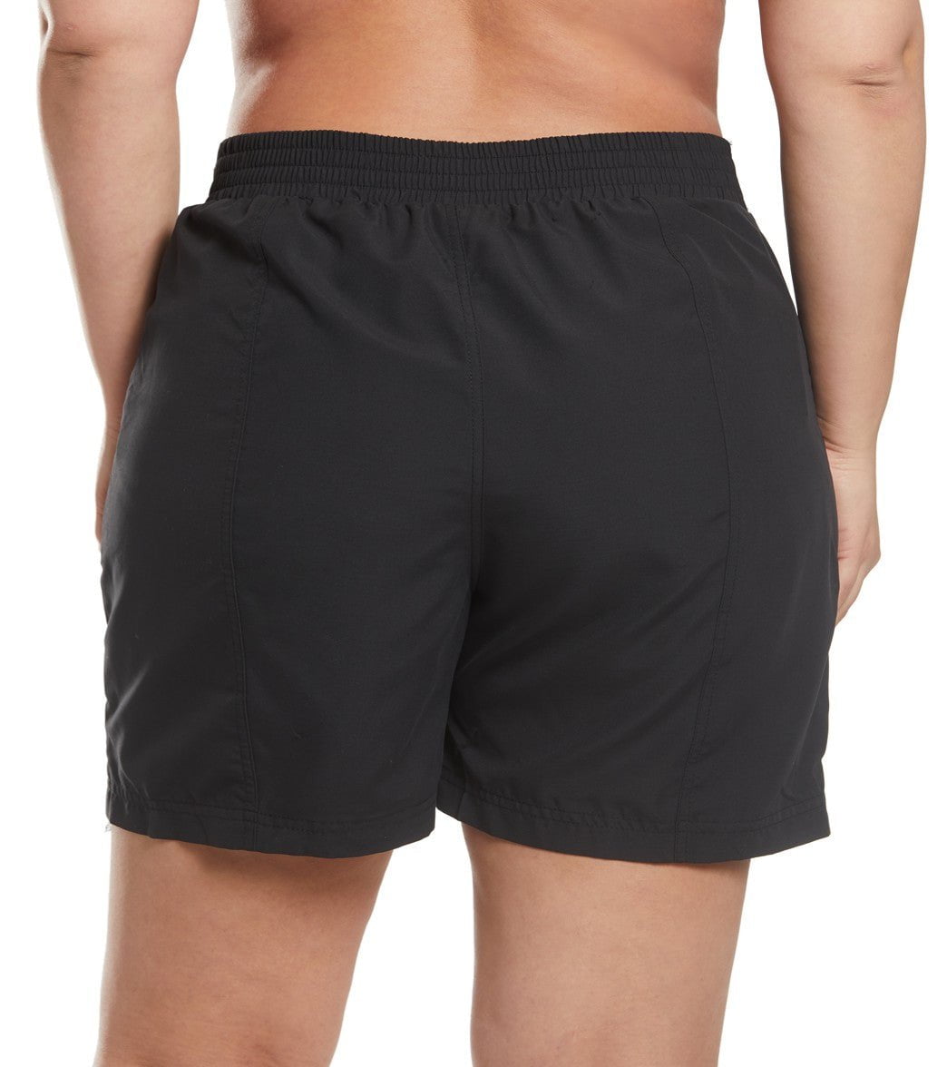 Model is wearing a solid black colored 6" inseam woven board short bottom.