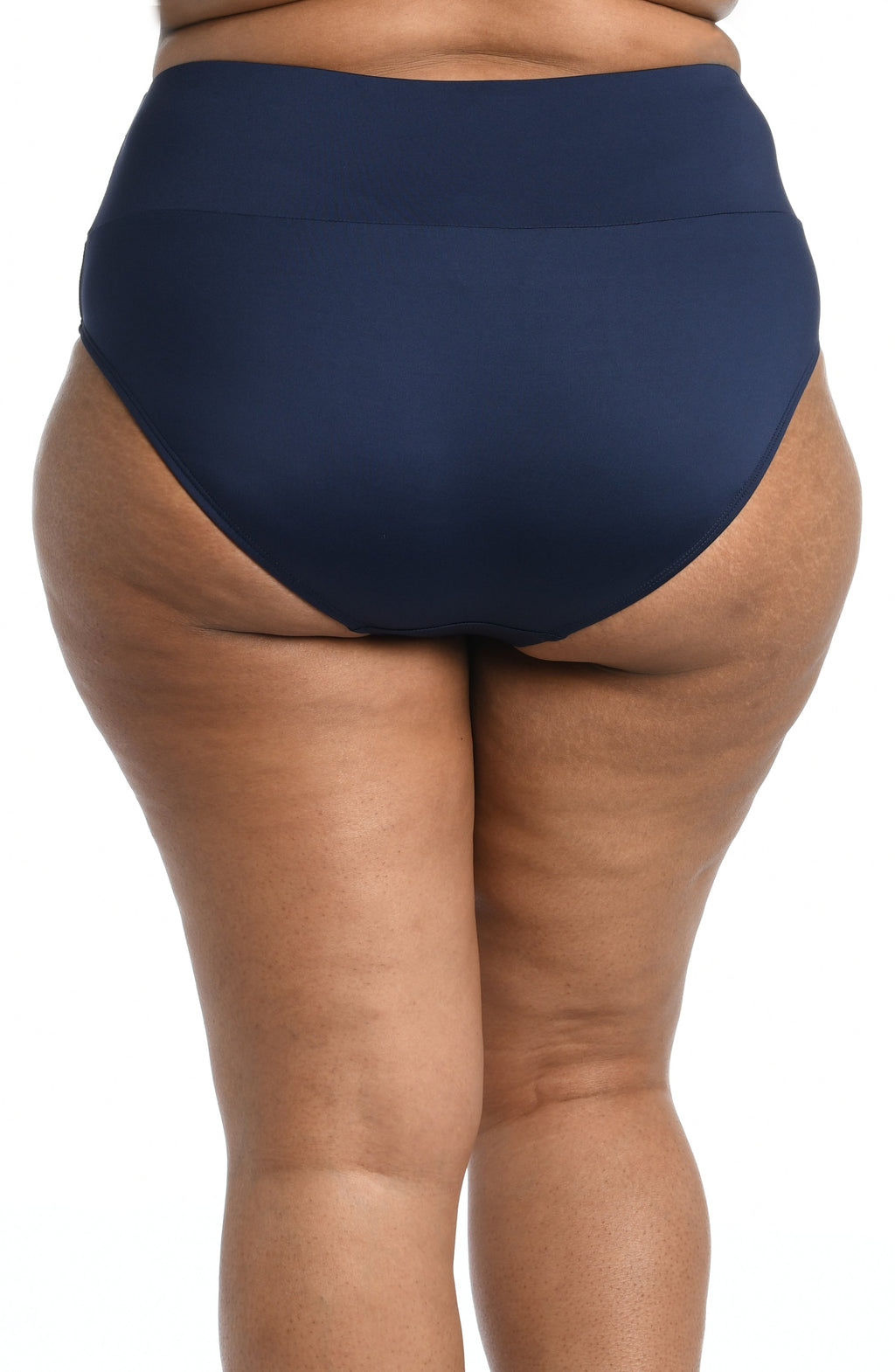 Model is wearing a solid midnight blue mid waist spliced hipster bikini bottom from our 24th & Ocean brand.