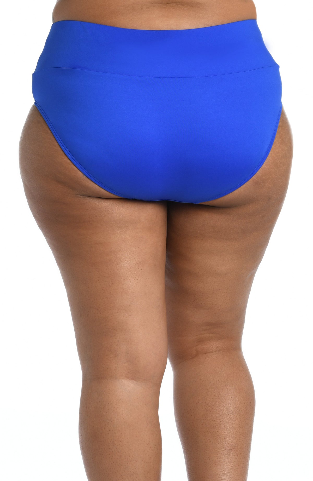 Model is wearing a solid midnight blue mid waist spliced hipster bikini bottom from our 24th & Ocean brand.